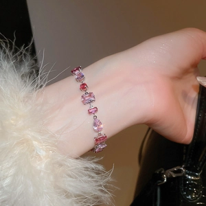Macro detail of the irregular pink zircon bracelet with multi-cut geometric gemstones