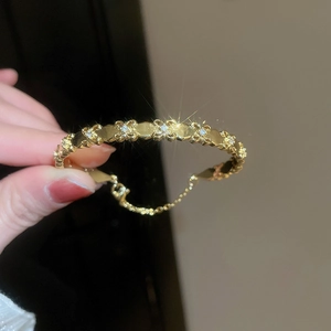 Close-up of 18k gold plated iris flower bracelet featuring sparkling zircon accents