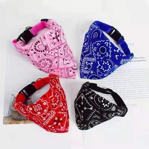 Detail view of four colorful printed pet bandanas with adjustable buckle collars for dogs