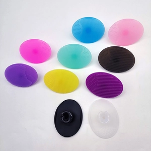 Detailed view of soft silicone facial cleansing brushes with suction cups in multiple colors
