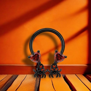 Black horseshoe ring featuring red heart gems and small black spider charms for Halloween