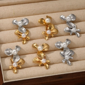 Three pairs of elegant stainless steel flower earrings with pearls in gold and silver finish