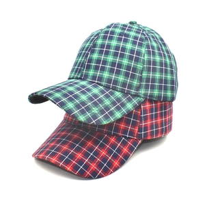 Colorful plaid baseball caps in green and red tartan patterns with a curved brim style