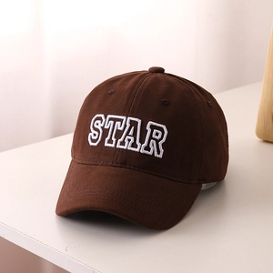Detailed embroidery of STAR letters on dark brown cotton fabric of kids baseball cap