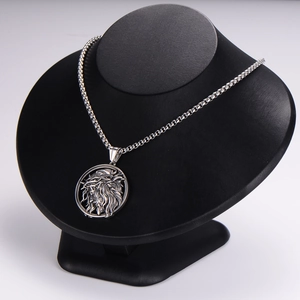 Detailed close-up of a silver vintage lion head medallion pendant on a box chain