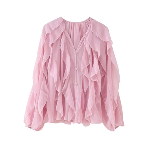 Detail of pink chiffon blouse with deep V-neck, layered ruffles and lantern sleeves
