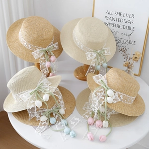 Flat top straw boater hat with delicate lace ribbon and tulip floral accents