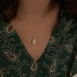Minimalist 925 sterling silver necklace with vintage oval embossed flower pendant on model