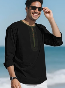 Detail of men's linen beach shirt with olive green trim and buttons on black fabric
