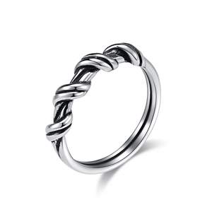 Minimalist silver stainless steel ring with a twisted wire rope texture on a white background