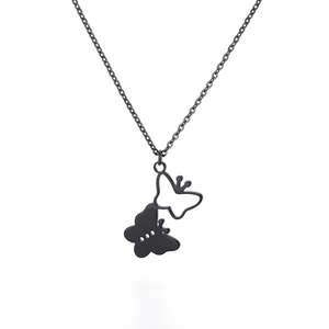 Detailed view of dual silver hollow and black solid butterfly pendants on steel chain