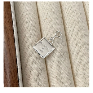 Macro shot of S925 sterling silver square pendant with Me+You and Love engravings