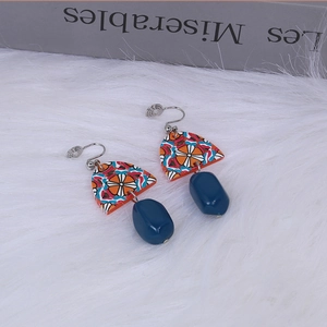 Retro acrylic geometric drop earrings with yellow and blue contrast on white fur