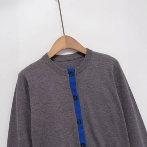 Women's crewneck knit cardigan in grey with blue contrast trim and black buttons