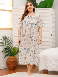 Detailed close-up of the square neckline with lace trim and bow on floral nightdress