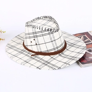 White and black checkered cowboy straw hat with brown braided rope for sun protection
