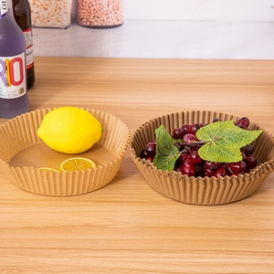 Close-up of disposable round paper liners holding fresh fruit on a wooden surface