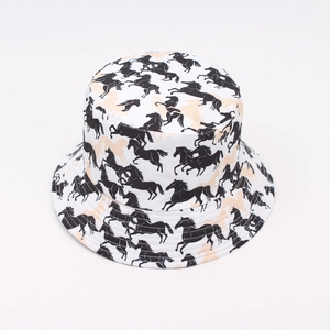 Detail shot of a white bucket hat with stylish black and beige horse print patterns