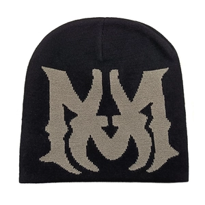 Detailed view of jacquard knitted fabric showing the gray M letter on a black beanie