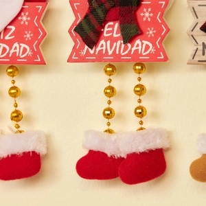 Christmas hanging decor with red EL NAVIDAD sign, green bow, and cute plush boots
