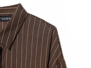 Detail of a brown striped shirt collar showing the size label and woven fabric texture