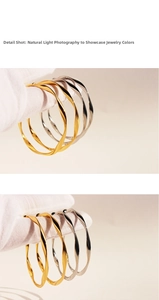 Close-up of twisted gold and silver minimalist bangles with spiral texture design