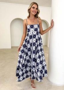Detail view of square grid and coconut tree floral pattern on blue bohemian summer maxi dress