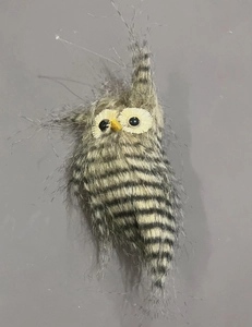 Detailed view of the fuzzy brown and grey owl ornament with realistic feathery texture