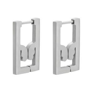 Macro view of geometric silver stainless steel rectangular earrings with abstract patterns