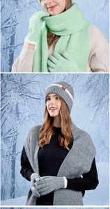 Close-up of winter knit set including a beanie with logo, scarf and touchscreen gloves