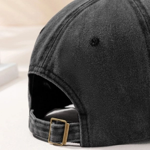 Rear view of washed dark grey cotton baseball cap with adjustable bronze metal buckle