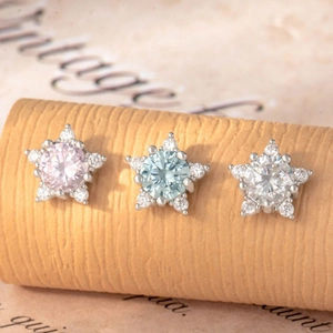 Star-shaped titanium steel cartilage earrings with pink, blue, and clear zircon stones