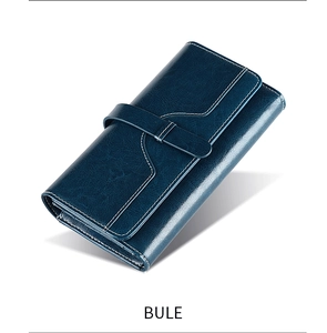 Detail view of a long blue oil wax leather wallet with flap closure and white contrast stitching