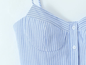 Detail of blue and white striped camisole top featuring front button closure and slim fit