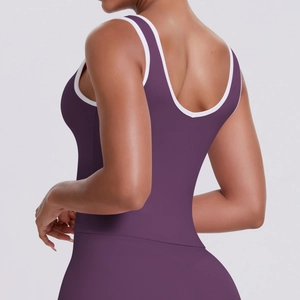 Détail du haut de yoga violet foncé avec dos en U et finitions blanches contrastées