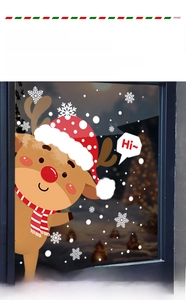 Close-up of reindeer Christmas window decals with snowflakes on glass in night setting