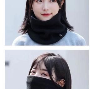 Detail view of black knitted neck warmer worn as a face mask and scarf in outdoor setting