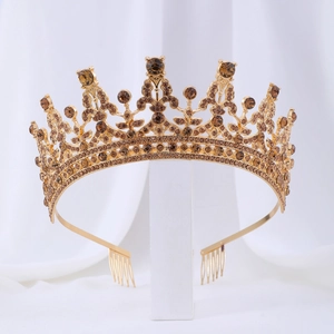 Detailed view of the gold crown bridal hairpiece with shimmering brown rhinestones