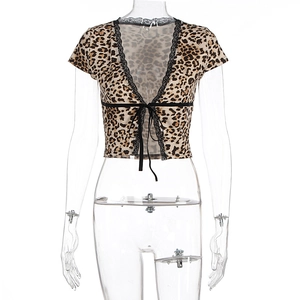 Close-up of leopard print crop top featuring black lace V-neck and front tie detail