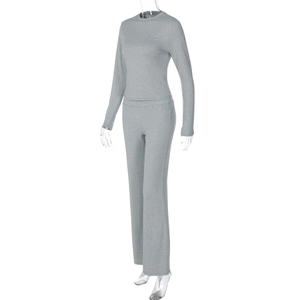 Detail of grey knitted long-sleeve top and high-waist flared pants set for women