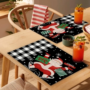 Detail of Christmas placemats featuring Santa Claus on black and white buffalo plaid pattern