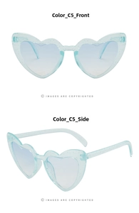 Detail of light blue heart-shaped sunglasses with fine glitter inserts and tinted lenses