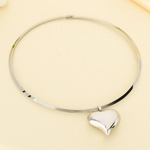 Detail of silver stainless steel choker necklace with a large hollow heart pendant