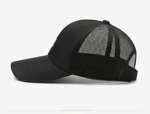 Side view of black quick-dry baseball cap featuring breathable mesh panels and curved brim