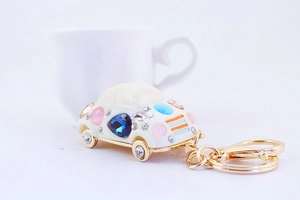 Detailed macro view of white car keychain with colorful gemstones and rhinestones