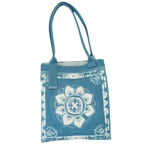 Blue knit tote bag with white floral pattern and geometric patterns in casual ethnic style