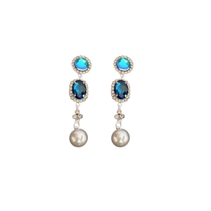 Elegant silver drop earrings set with blue crystals and white pearls on white background