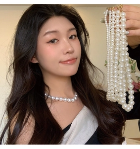Detail showing various pearl sizes ranging from 8mm to 14mm on a vintage necklace