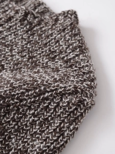 Close-up of thick knit texture with brown and cream mixed yarn on short sleeve top