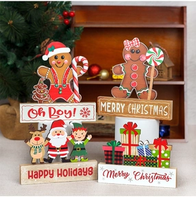 Detail of wooden Christmas gingerbread man table ornaments with festive greetings